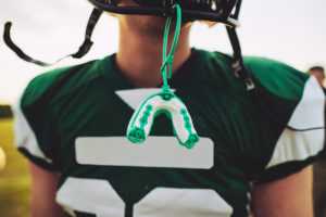 Closeup,of,a,mouthguard,hanging,off,the,helmet,of,an